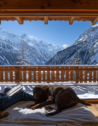 A man with his two dogs on the balcony of a pet-friendly vacation rental in Courchevel, France