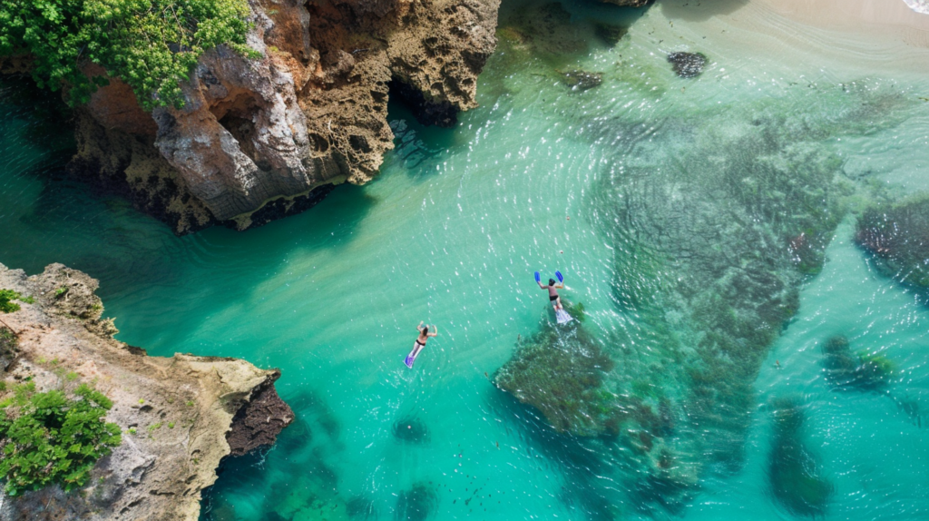 Snorkelers enjoy the vibrant underwater life near a secluded beach on a sunny day in Dunmore Town.