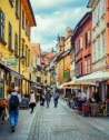 The charming streets of Ljubljana, Slovenia, with colorful buildings and outdoor cafes, people walking and enjoying their day.