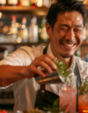 A bartender at Bar BenFiddich, Tokyo, mixing a cocktail with fresh herbs and spices.